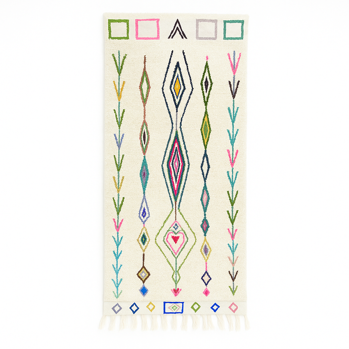 Handmade Moroccan runner rug with colorful geometric and tribal motifs on a white wool background, crafted by Berber artisans.