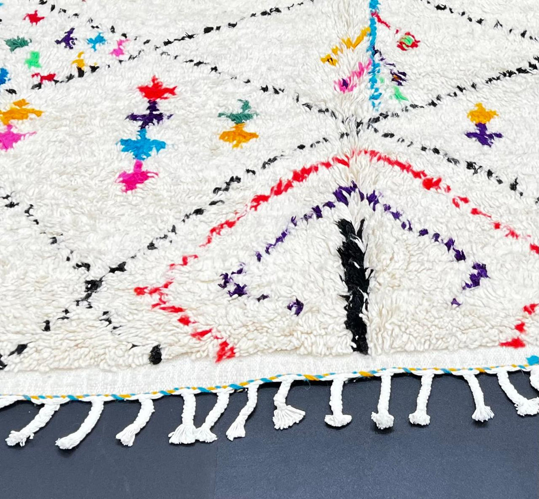 Handmade ivory Moroccan wool runner rug with colorful Berber motifs inside black diamond Beni Ourain pattern