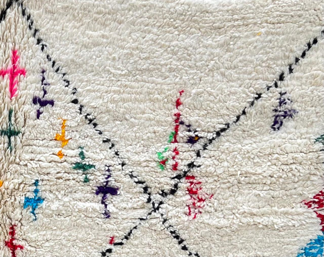 Handmade ivory Moroccan wool runner rug with colorful Berber motifs inside black diamond Beni Ourain pattern