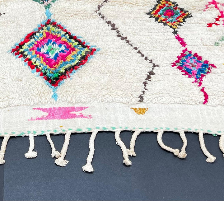 Handmade Moroccan wool runner rug with colorful Berber diamond motifs on a white background