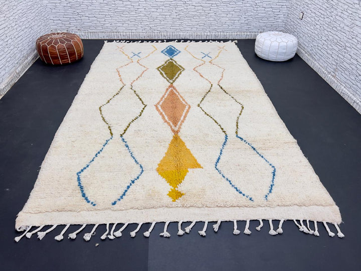 Handwoven Moroccan wool rug with colorful diamond geometric design on ivory background