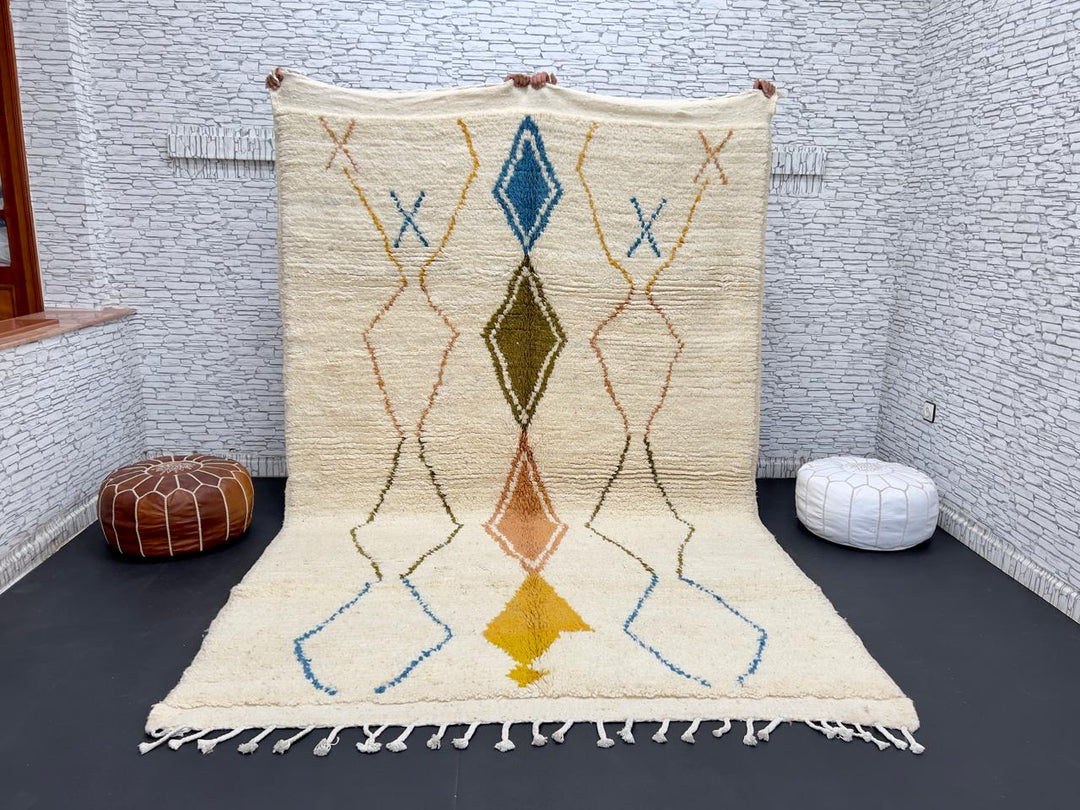 Handwoven Moroccan wool rug with colorful diamond geometric design on ivory background