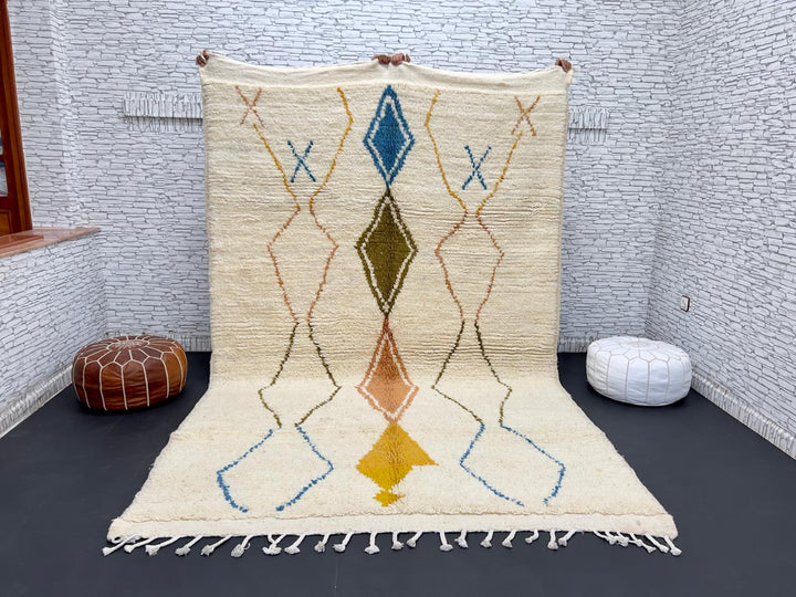 Handwoven Moroccan wool rug with colorful diamond geometric design on ivory background