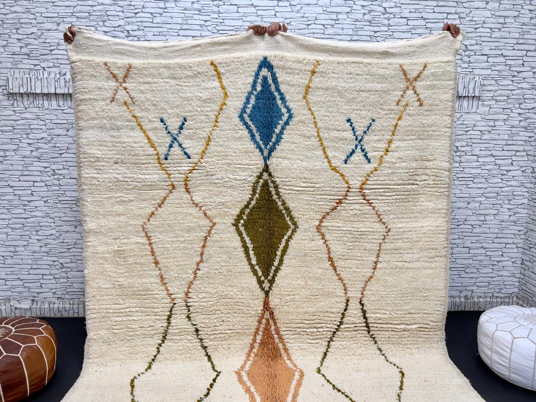 Handwoven Moroccan wool rug with colorful diamond geometric design on ivory background