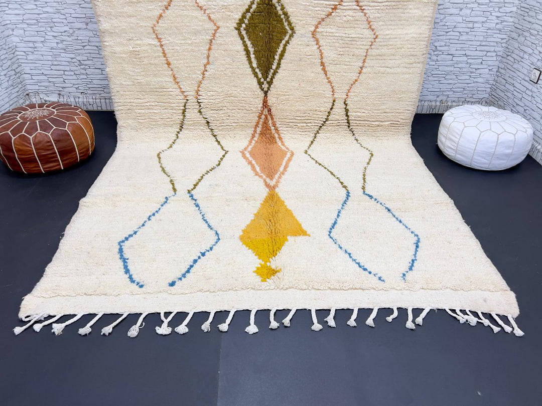 Handwoven Moroccan wool rug with colorful diamond geometric design on ivory background