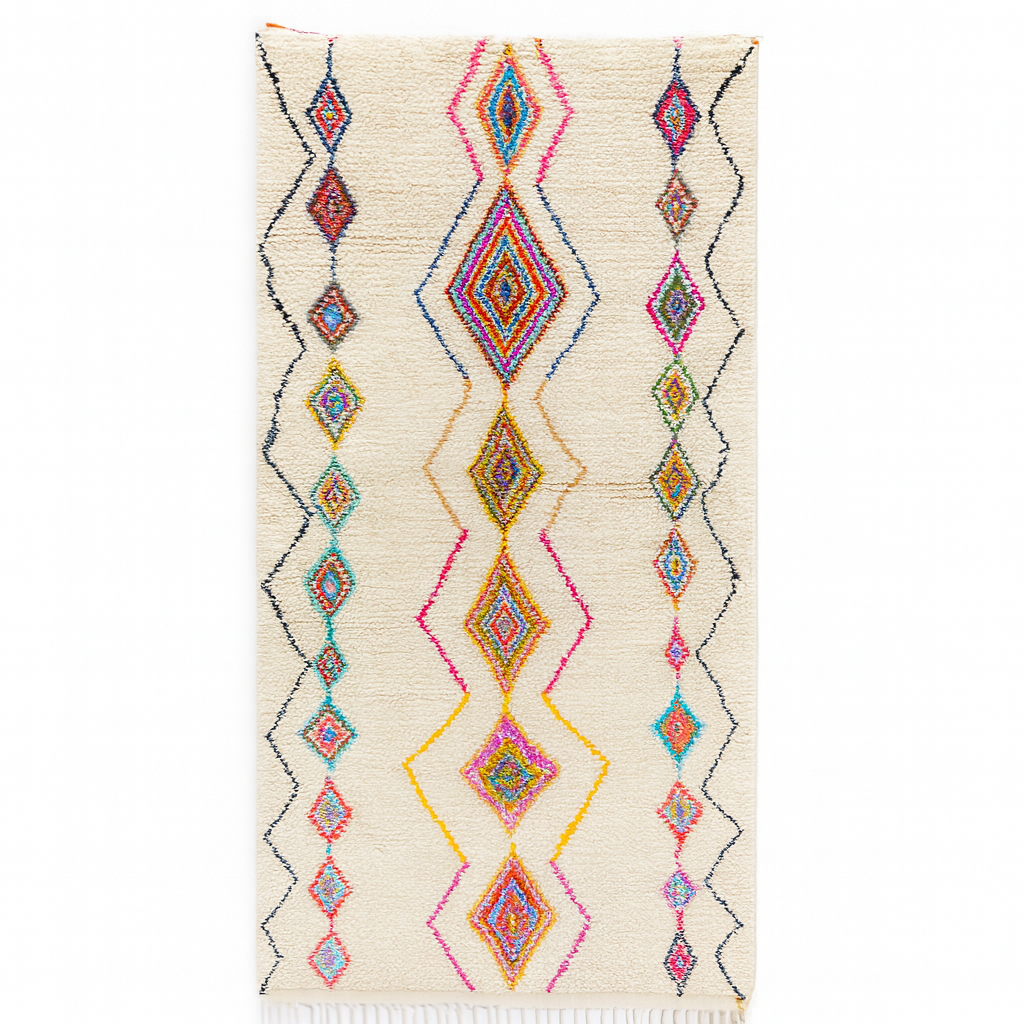 Handmade Moroccan runner rug with colorful diamond patterns on a white  background, crafted from natural wool by Berber artisans.
