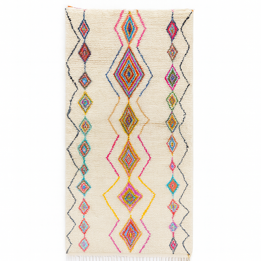 Handmade Moroccan runner rug with colorful diamond patterns on a white  background, crafted from natural wool by Berber artisans.