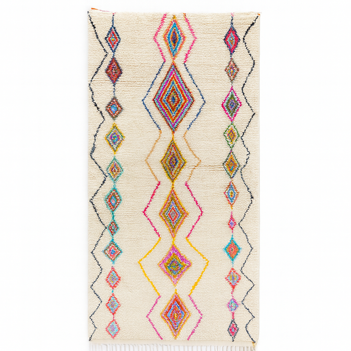 Handmade Moroccan runner rug with colorful diamond patterns on a white  background, crafted from natural wool by Berber artisans.