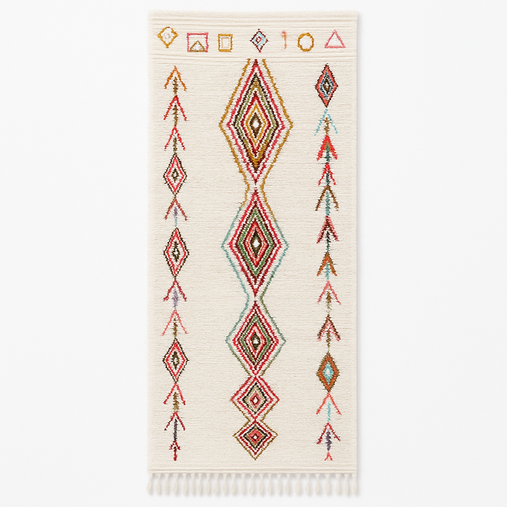 Handmade Moroccan wool runner rug with colorful diamond and arrow Berber motifs on a white background