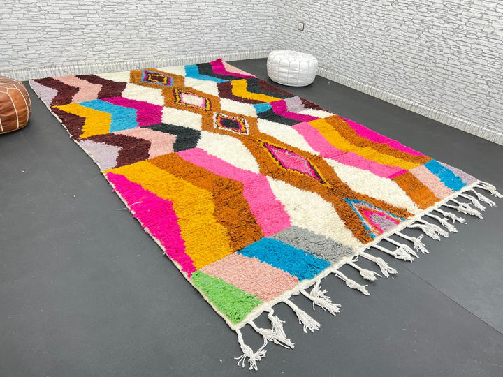 Colorful Moroccan Azilal wool rug with geometric diamond pattern in vibrant hues