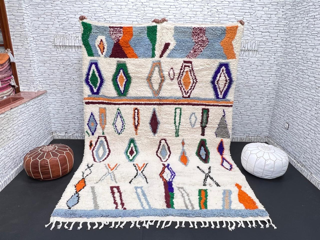 colorful handmade moroccan berber rug with geometric patterns on ivory wool background