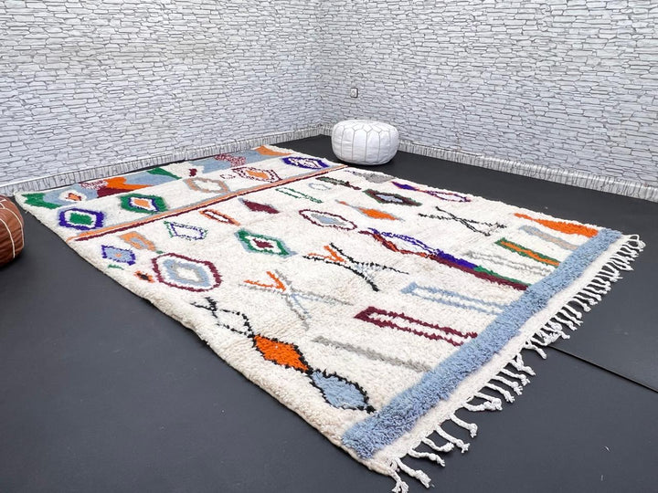 colorful handmade moroccan berber rug with geometric patterns on ivory wool background