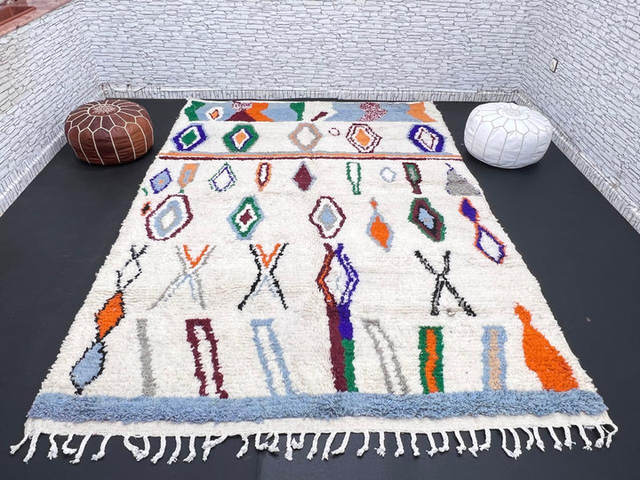 colorful handmade moroccan berber rug with geometric patterns on ivory wool background