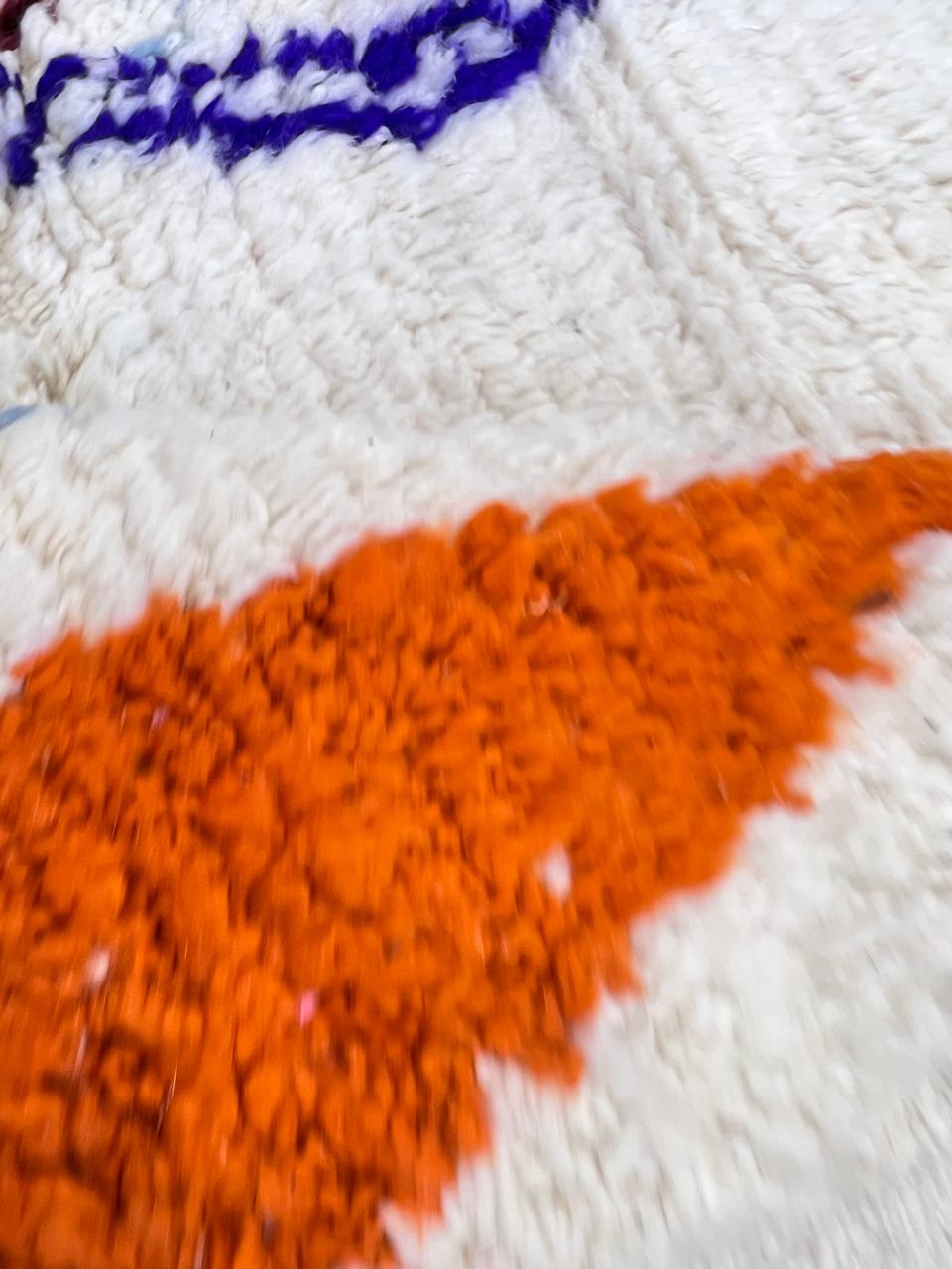 colorful handmade moroccan berber rug with geometric patterns on ivory wool background