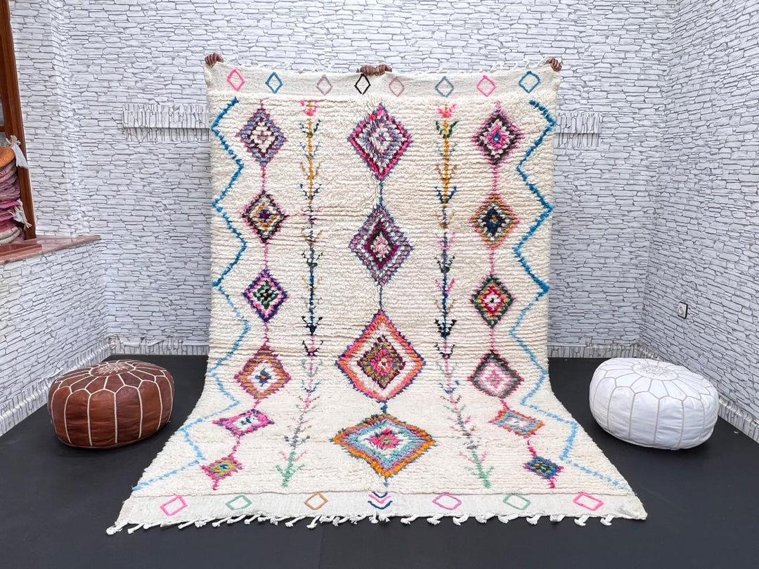Handmade Moroccan Berber rug with colorful diamond patterns on white wool