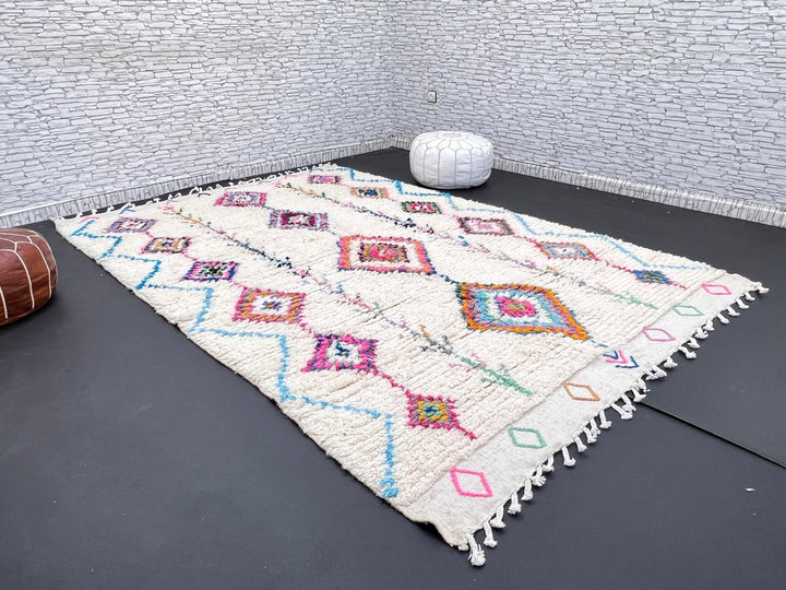Handmade Moroccan Berber rug with colorful diamond patterns on white wool