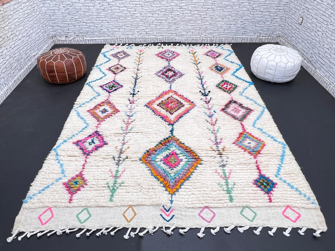 Handmade Moroccan Berber rug with colorful diamond patterns on white wool