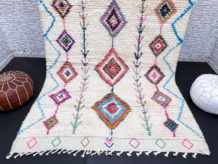Handmade Moroccan Berber rug with colorful diamond patterns on white wool