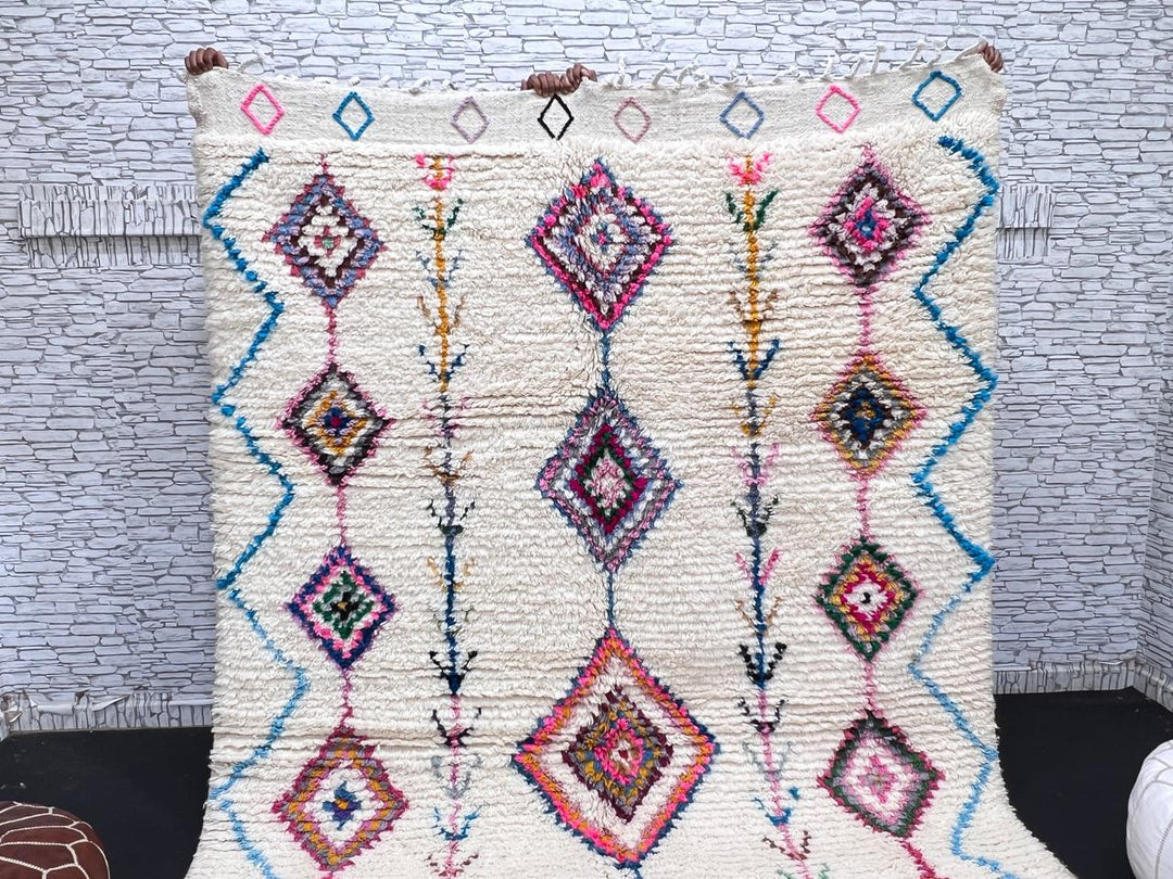 Handmade Moroccan Berber rug with colorful diamond patterns on white wool