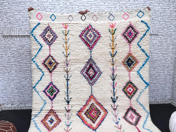 Handmade Moroccan Berber rug with colorful diamond patterns on white wool