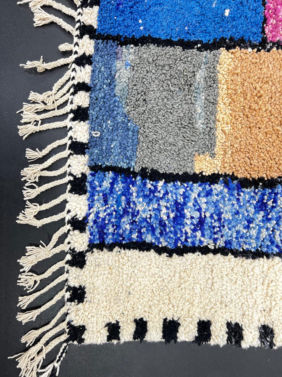 Colorful handmade Moroccan runner rug with abstract wool design, vibrant textured blocks and black border, shag Berber carpet