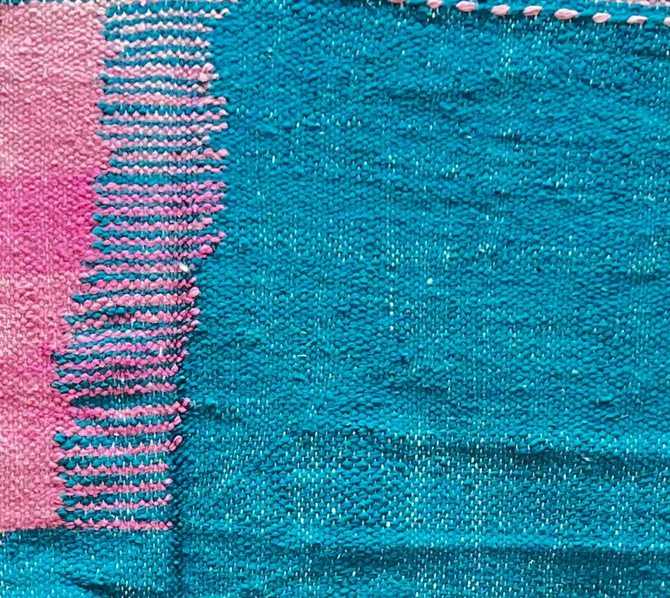 Handmade Moroccan runner rug with pink and blue geometric design, white accents and flatwoven kilim texture