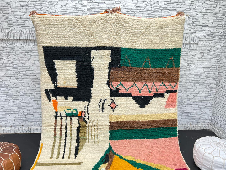 Handwoven colorful Moroccan wool rug with abstract geometric design in pink, yellow, green, and black tones