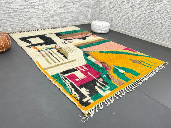 Handwoven colorful Moroccan wool rug with abstract geometric design in pink, yellow, green, and black tones