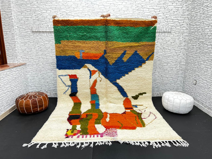 Colorful Moroccan wool rug with abstract desert and mountain design, handmade by Berber artisans