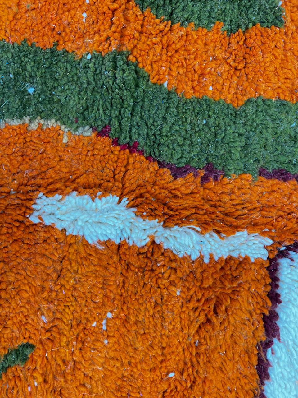 Colorful Moroccan wool rug with abstract desert and mountain design, handmade by Berber artisans