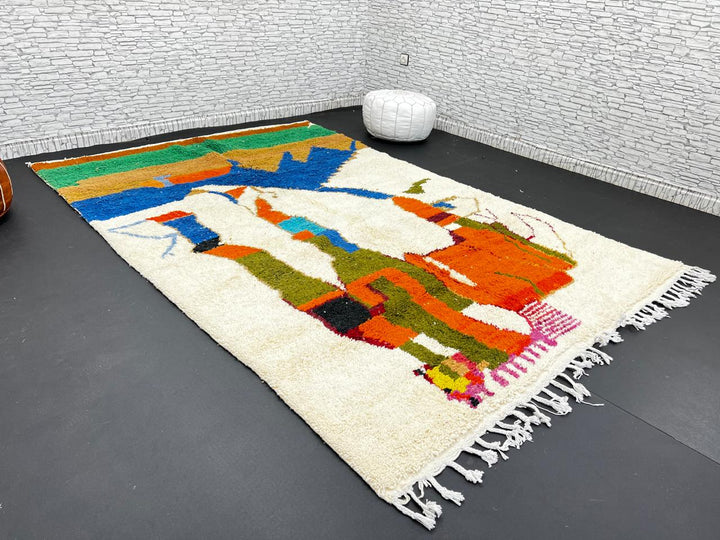 Colorful Moroccan wool rug with abstract desert and mountain design, handmade by Berber artisans
