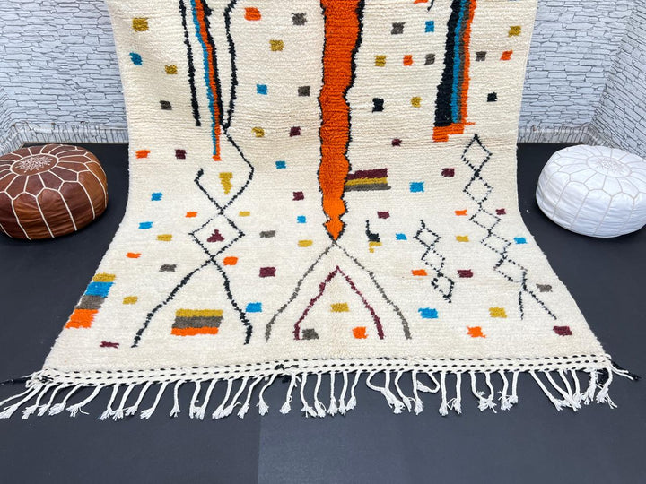 Handwoven Moroccan wool rug with multicolor geometric motifs on an ivory background, colorful Berber rug