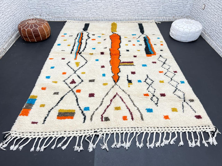 Handwoven Moroccan wool rug with multicolor geometric motifs on an ivory background, colorful Berber rug