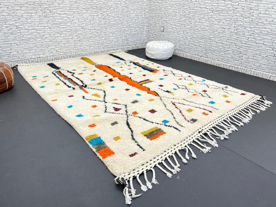 Handwoven Moroccan wool rug with multicolor geometric motifs on an ivory background, colorful Berber rug