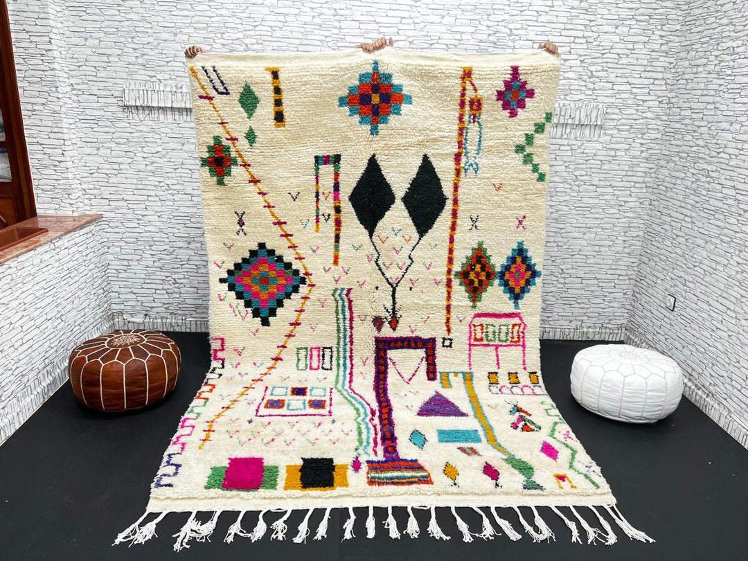 Handwoven colorful Moroccan wool rug with geometric Berber motifs on ivory background