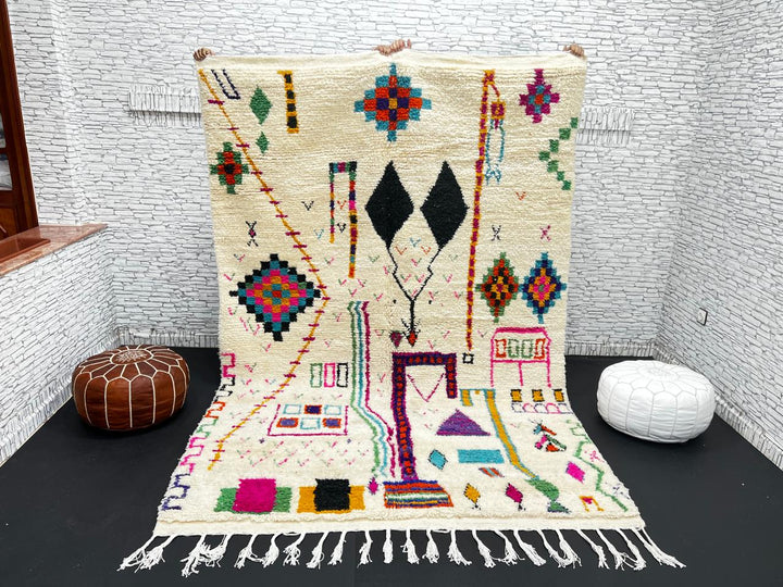 Handwoven colorful Moroccan wool rug with geometric Berber motifs on ivory background