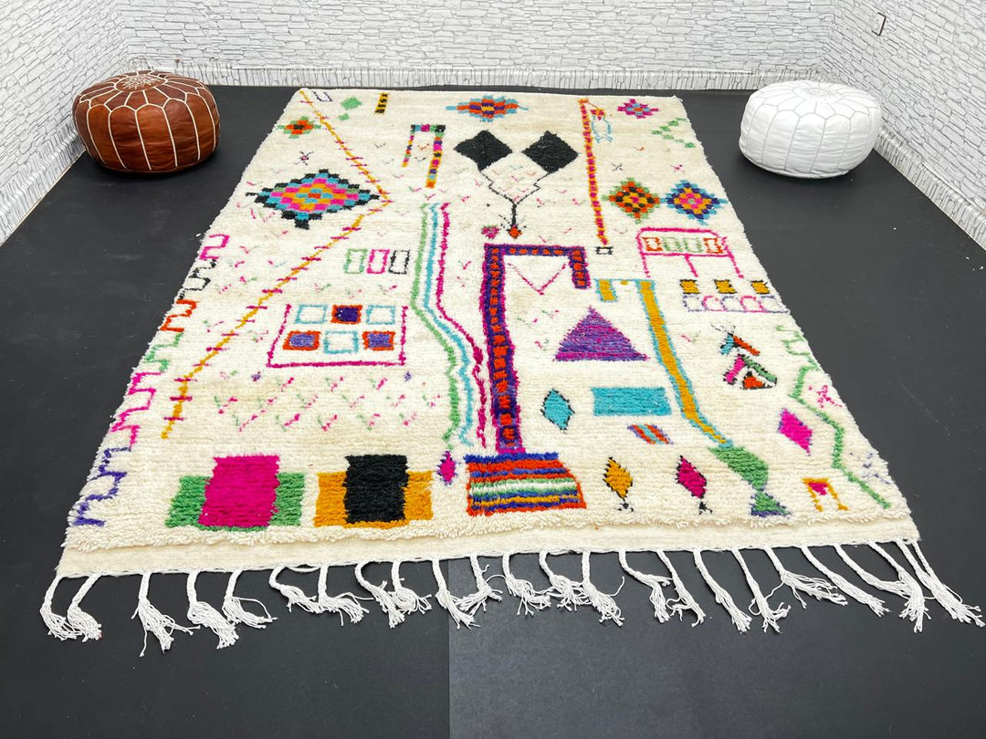 Handwoven colorful Moroccan wool rug with geometric Berber motifs on ivory background