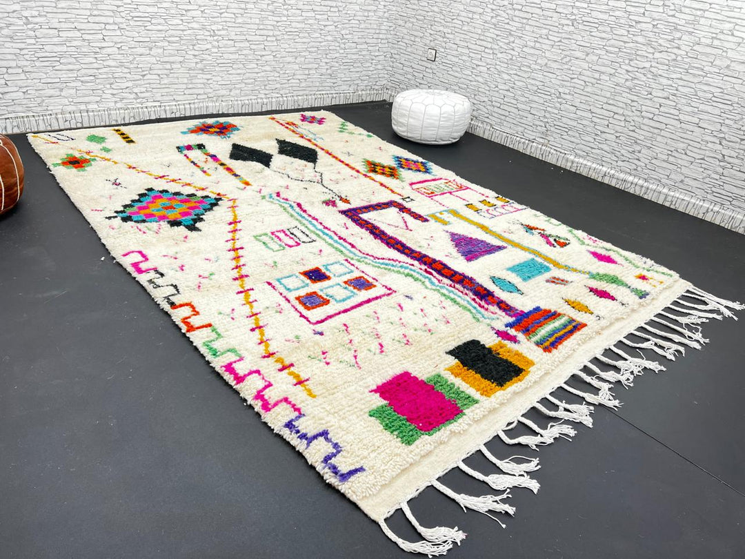 Handwoven colorful Moroccan wool rug with geometric Berber motifs on ivory background