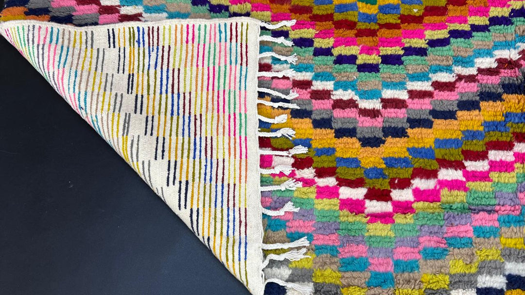 Colorful Moroccan wool rug with layered geometric Berber pattern and multicolor stripes