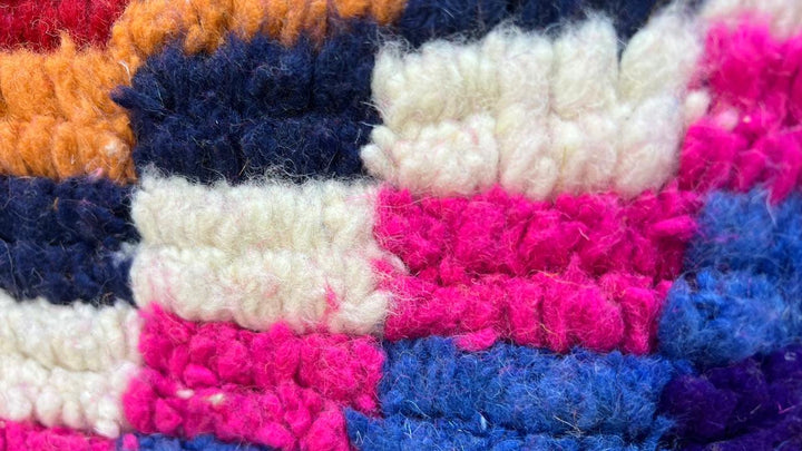 Colorful Moroccan wool rug with layered geometric Berber pattern and multicolor stripes