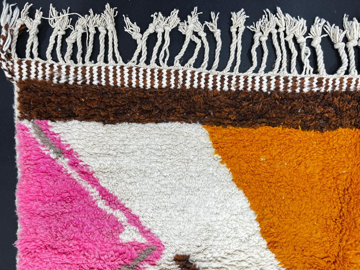 Colorful handmade Moroccan wool runner rug with pink, brown, orange, and green geometric Berber design