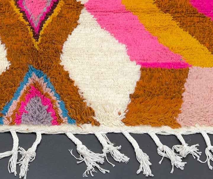 Handmade colorful Moroccan wool runner rug with zigzag geometric patterns in pink, teal, brown, mustard, and ivory tones