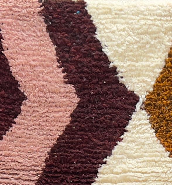 Handmade colorful Moroccan wool runner rug with zigzag geometric patterns in pink, teal, brown, mustard, and ivory tones