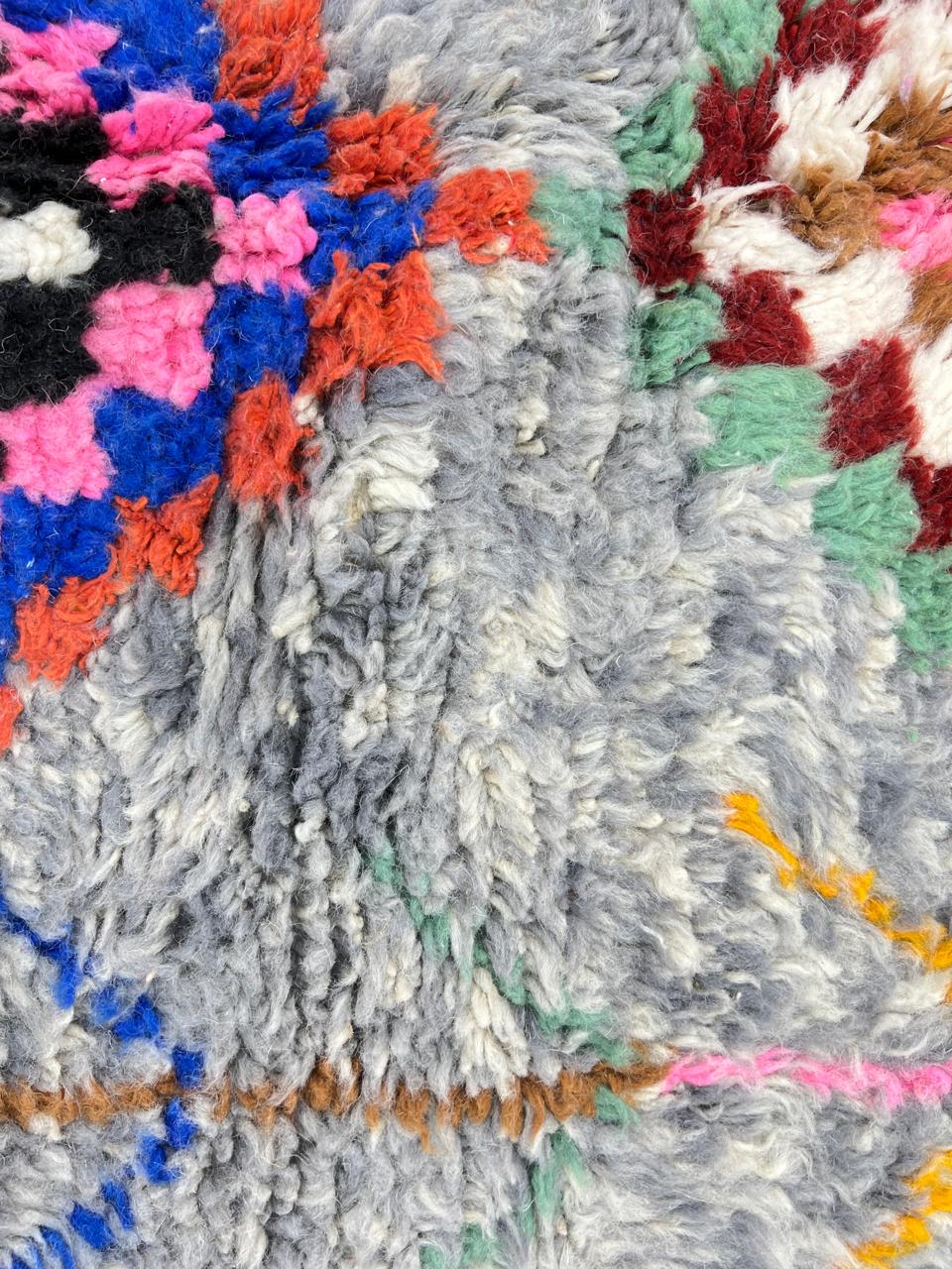Colorful Moroccan wool runner rug with multicolor diamond patterns on a gray background