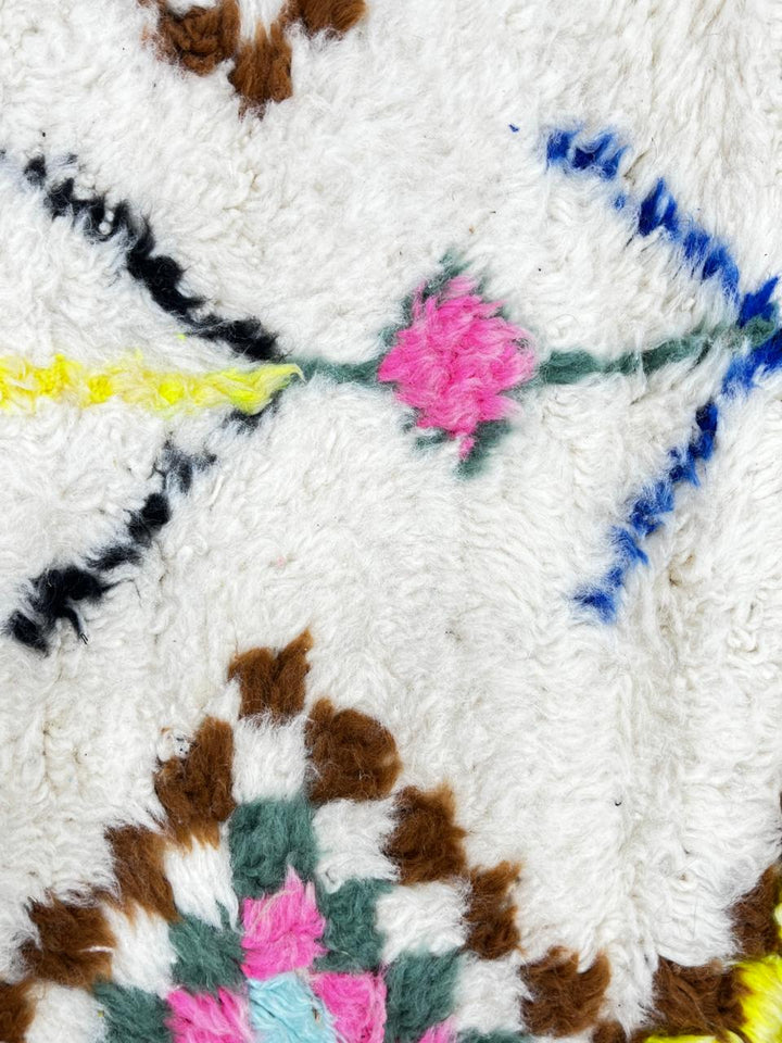 Handmade Moroccan Berber runner rug with colorful diamond tribal patterns on white background, traditional wool hallway runner