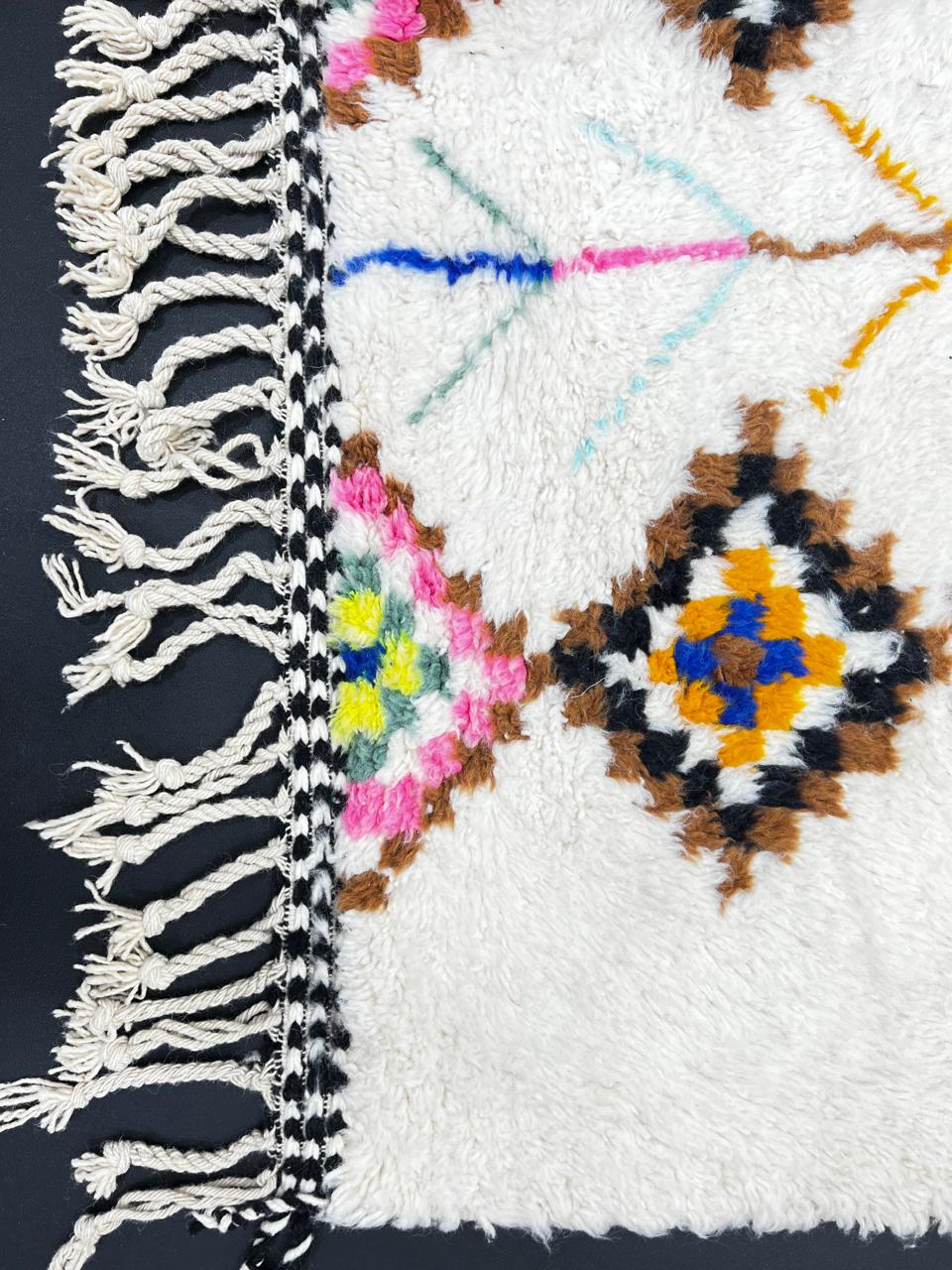 Handmade Moroccan Berber runner rug with colorful diamond tribal patterns on white background, traditional wool hallway runner