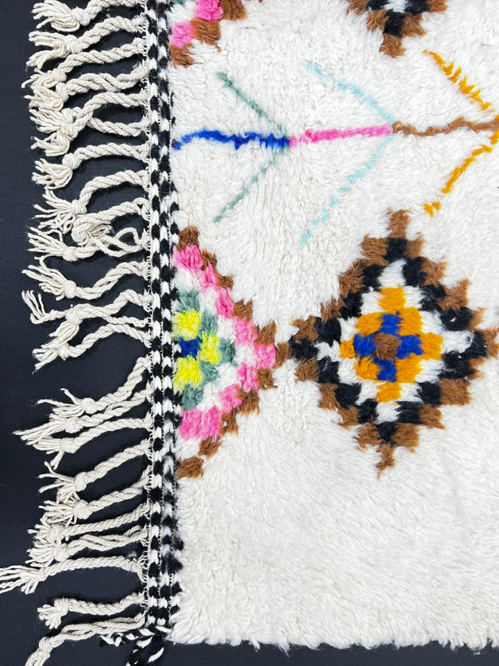 Handmade Moroccan Berber runner rug with colorful diamond tribal patterns on white background, traditional wool hallway runner