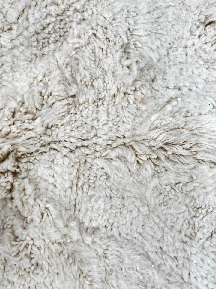 Handwoven cream Beni Ourain Moroccan wool rug with subtle chevron line pattern