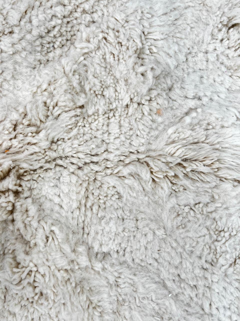 Handwoven cream Beni Ourain Moroccan wool rug with subtle chevron line pattern