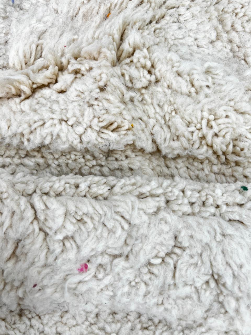 Handwoven cream Beni Ourain Moroccan wool rug with subtle chevron line pattern